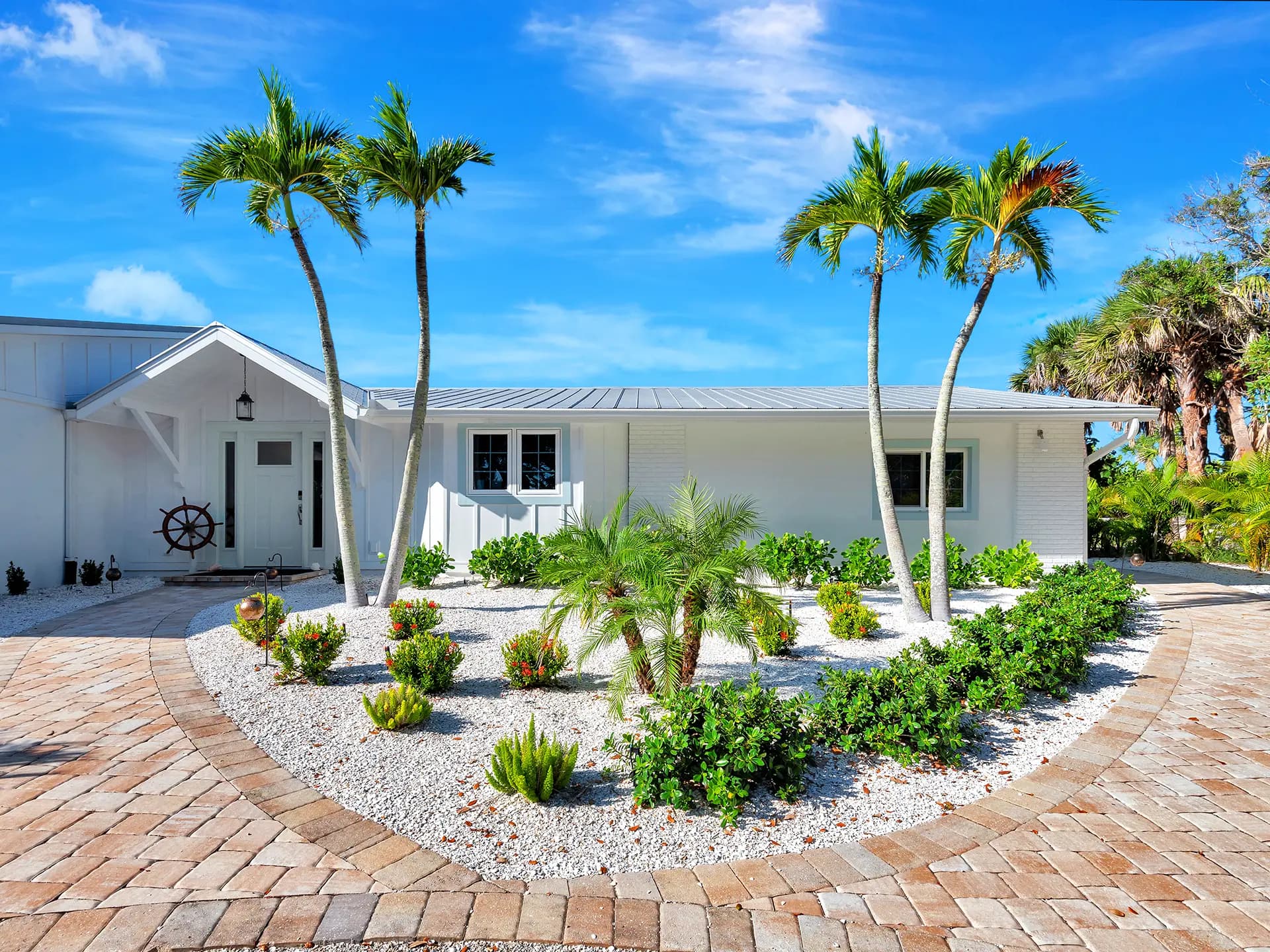 Property Exterior of a luxury residential property in Englewood, Florida. This stunning front exterior view of the luxury property, highlighting professional landscaping and custom architectural lines on the Florida Gulf Coast, captured with professional real estate media standards.